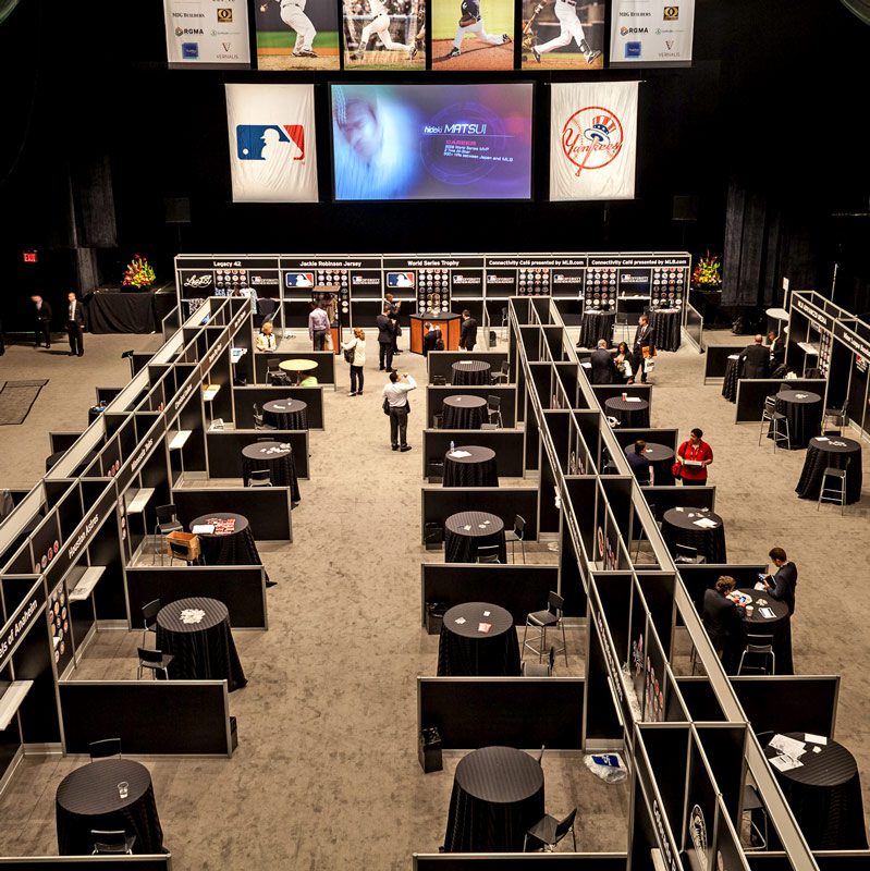 A spacious room featuring multiple tables and chairs arranged for gatherings or meetings.